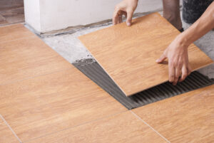 master puts the ceramic tiles on the floor